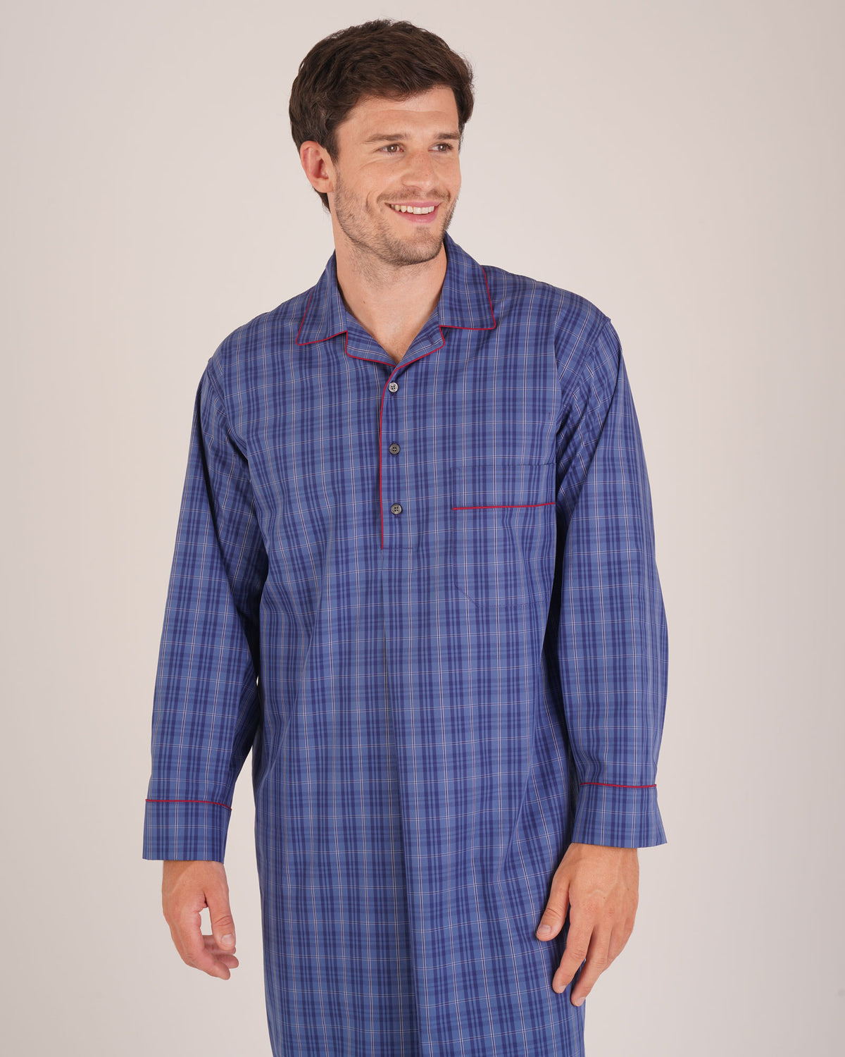 Bonsoir of London Men’s Edward Blue Plaid Classic Cotton Nightshirt, featuring a blue plaid check design, four-button placket, shirt-tail hem and generously cut fit, half body shot on a model.