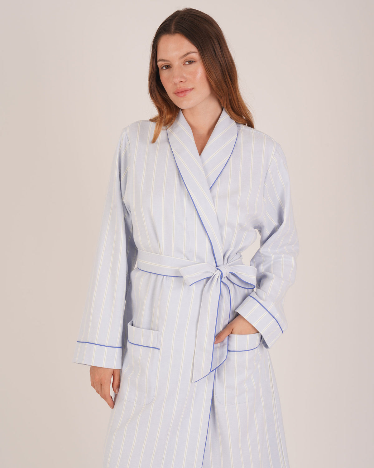 Bonsoir of London Women’s Isla Blue White Stripe Brushed Cotton Dressing Gown, featuring a blue and white striped design, shot on a model.