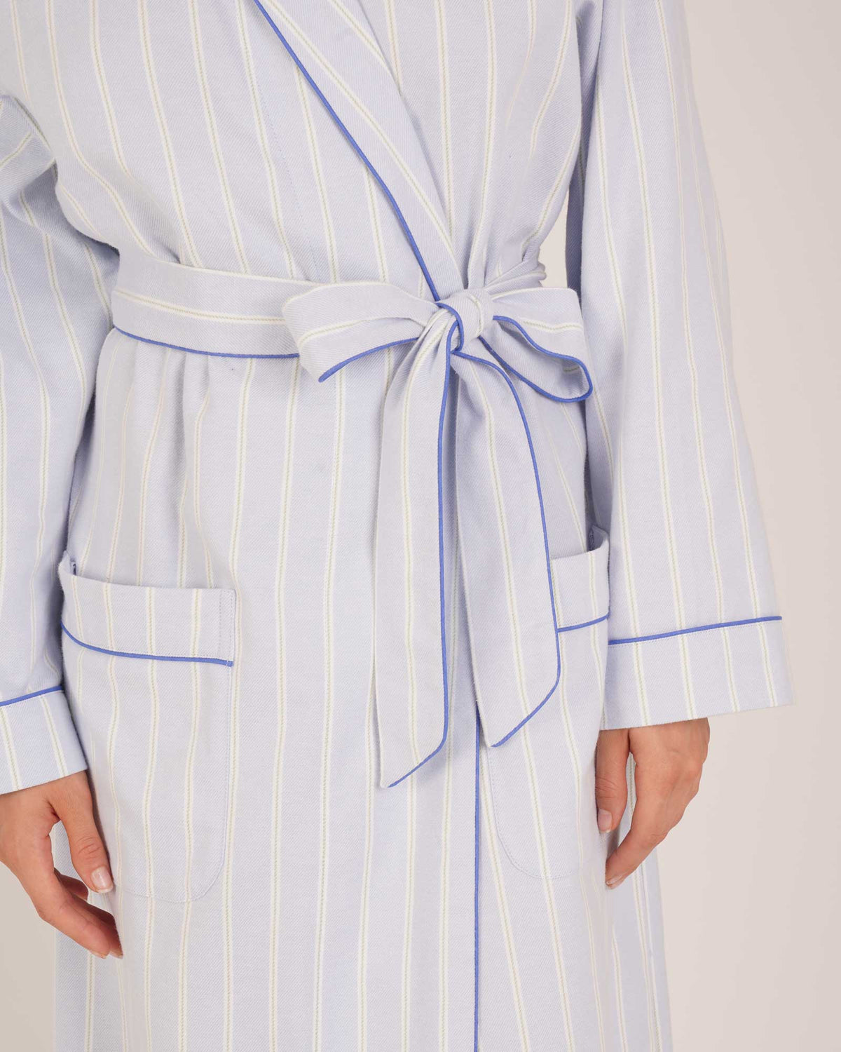Bonsoir of London Women’s Isla Blue White Stripe Brushed Cotton Dressing Gown, featuring a blue and white striped design, shot on a model close up.