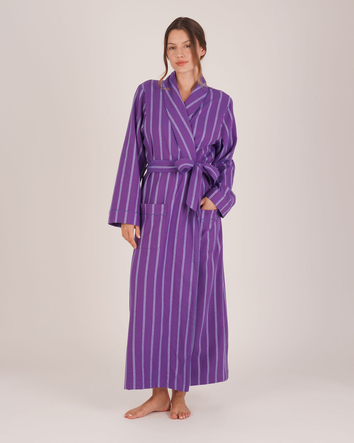 Bonsoir of London Women’s Lily Purple Stripe Brushed Cotton Dressing Gown, featuring a purple striped design, shot on a model.