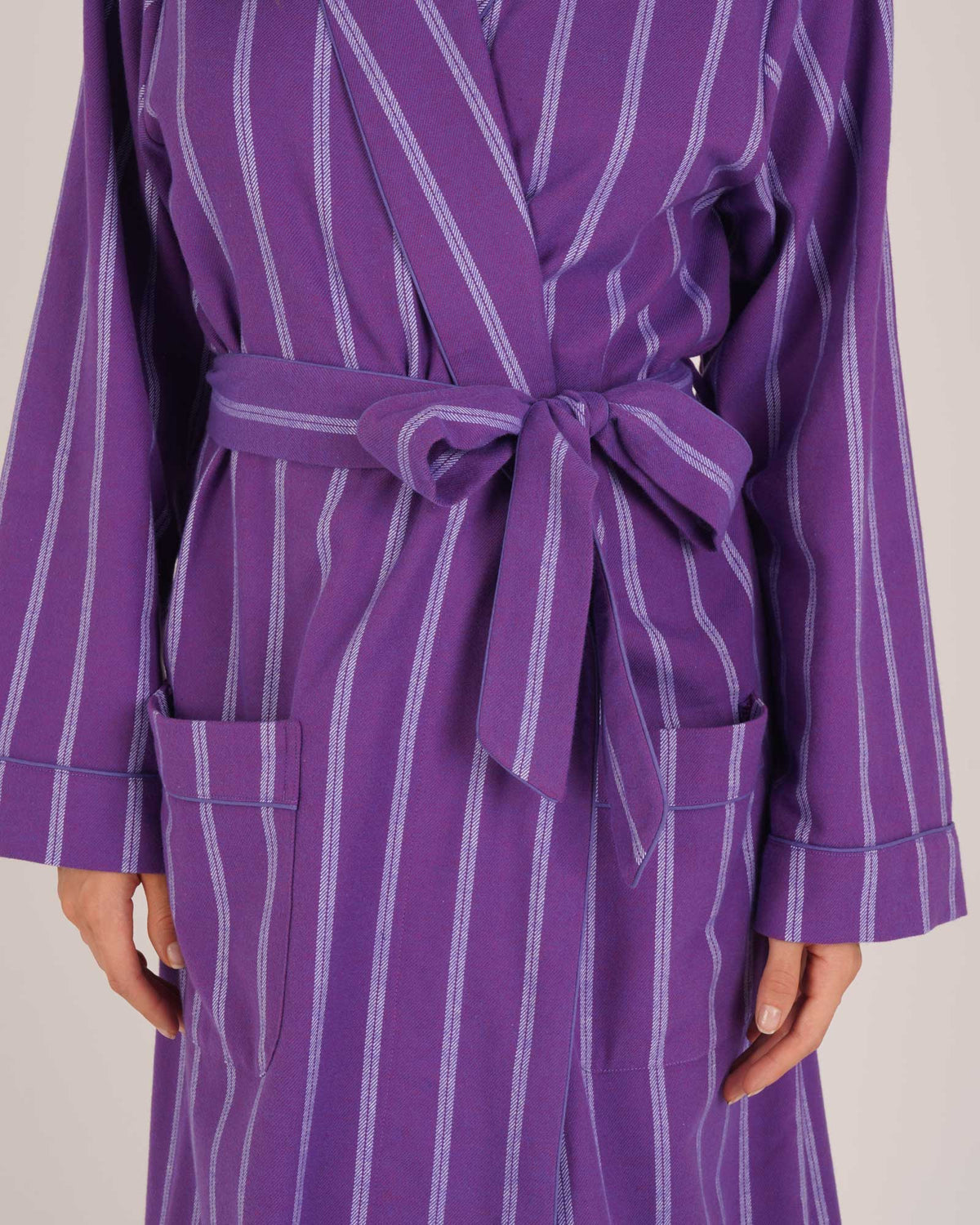 Bonsoir of London Women’s Lily Purple Stripe Brushed Cotton Dressing Gown, featuring a purple striped design, shot on a model close up.
