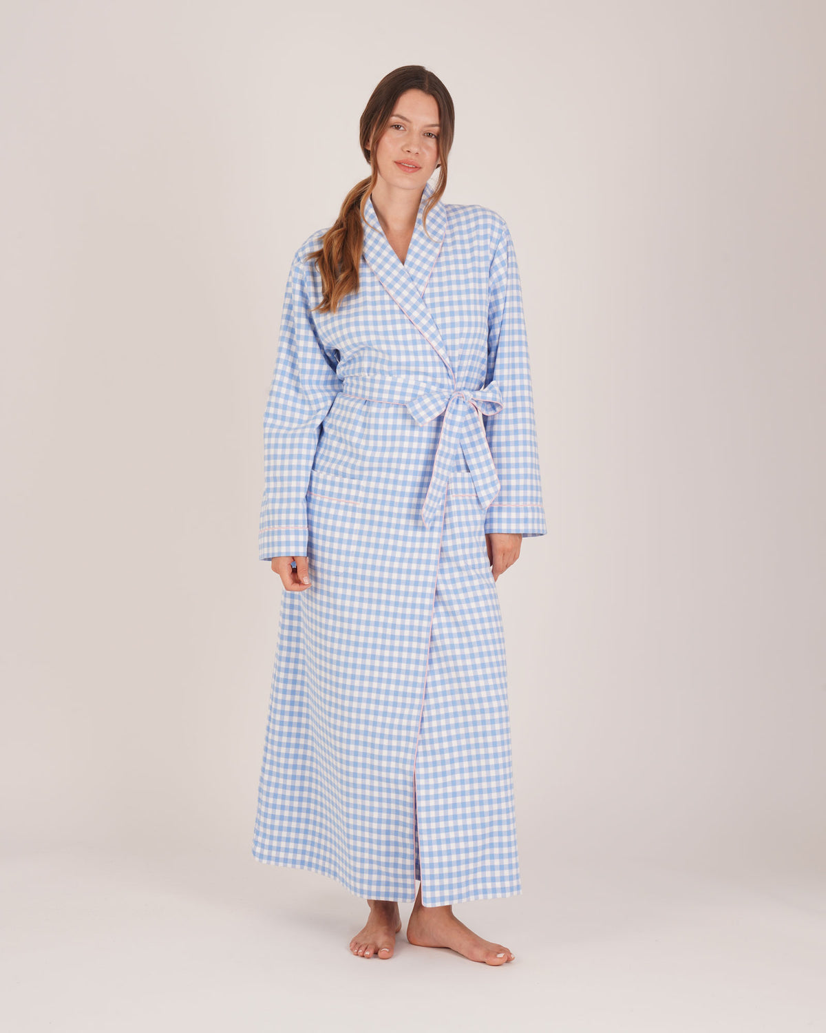 Bonsoir of London Women’s Poppy Blue White Gingham Brushed Cotton Dressing Gown, featuring a blue and white gingham check design, pink piping detail, shot on a model.