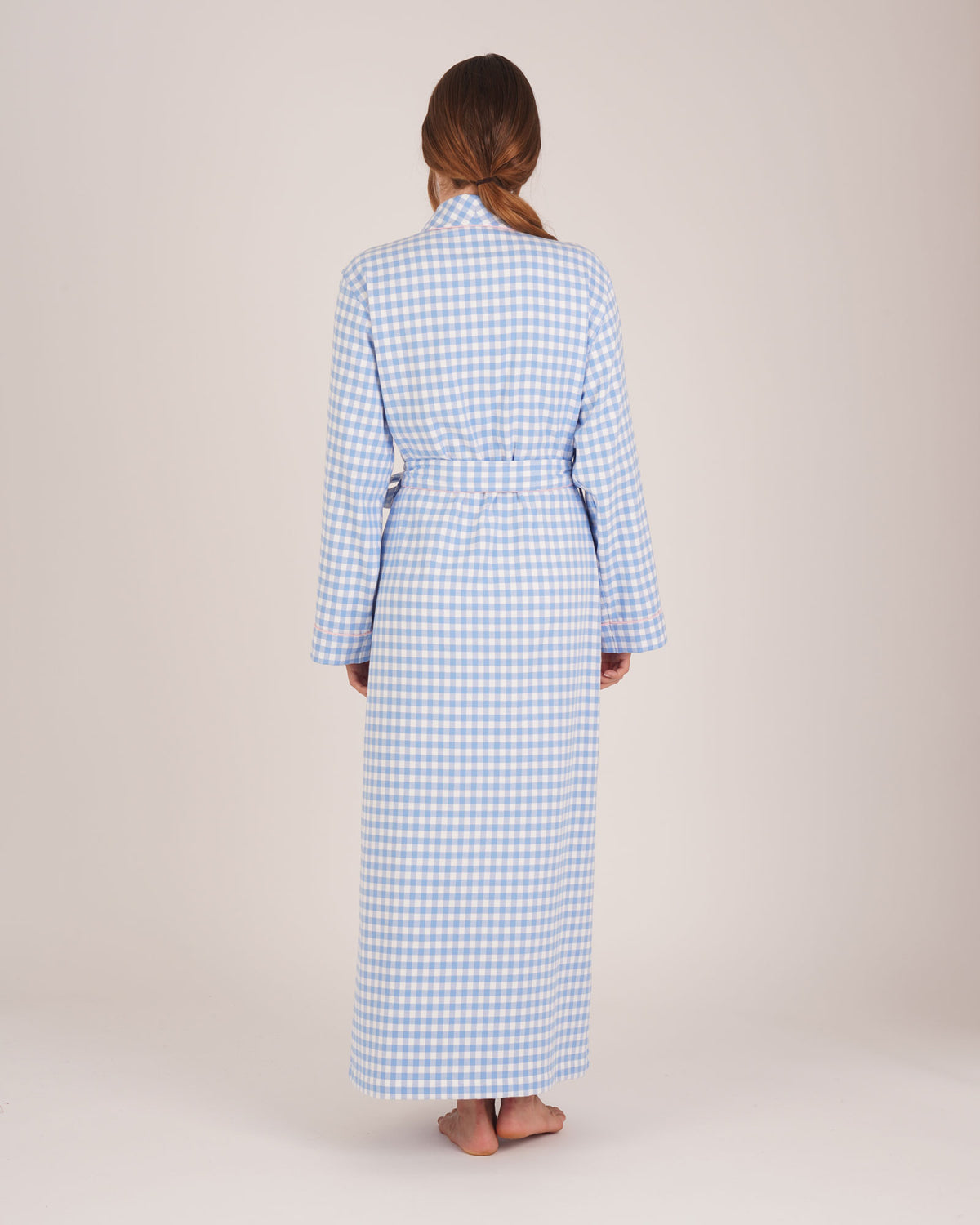 Bonsoir of London Women’s Poppy Blue White Gingham Brushed Cotton Dressing Gown, featuring a blue and white gingham check design, pink piping detail, shot on a model from back.
