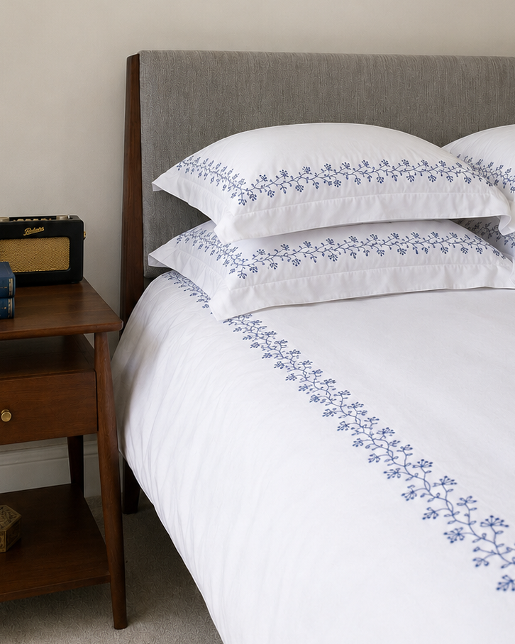 Bonsoir of London Kensington duvet set in Navy, featuring white 100% cotton duvet and pillowcases with navy floral embroidery.