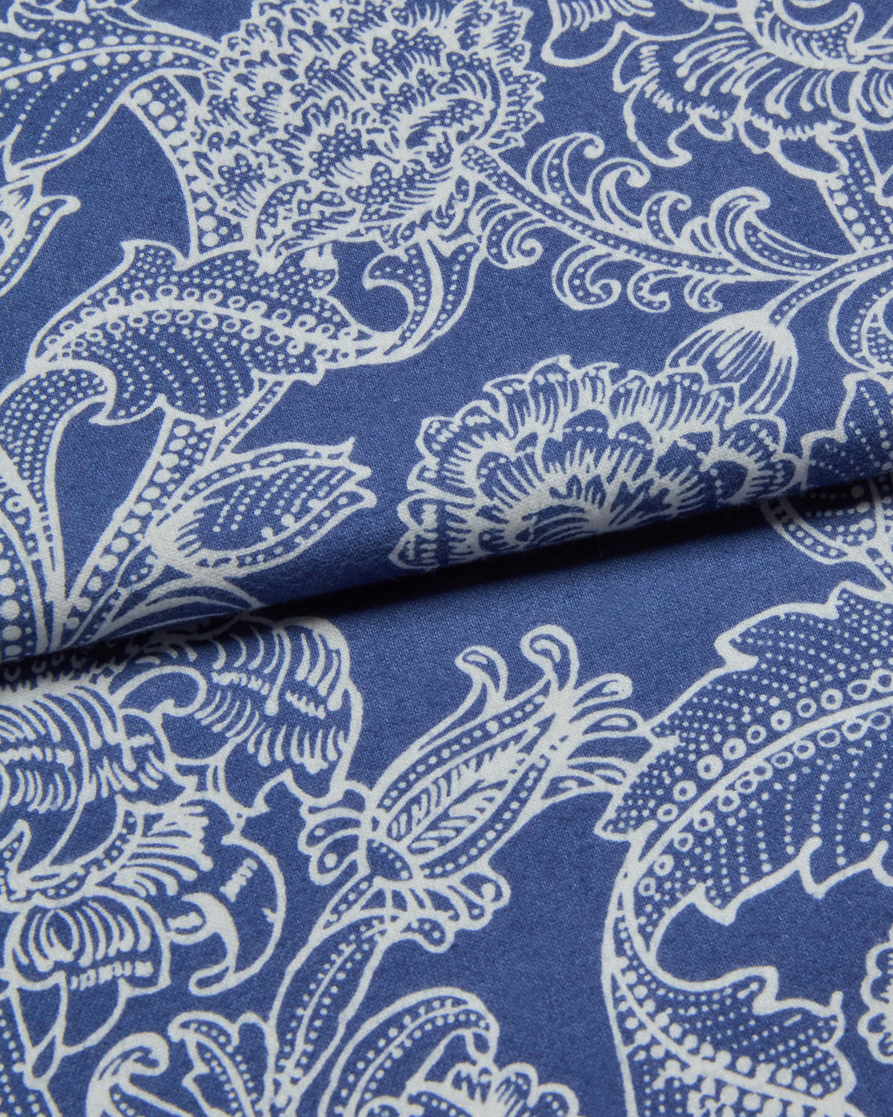 Blue fabric with white floral and leaf paisley pattern