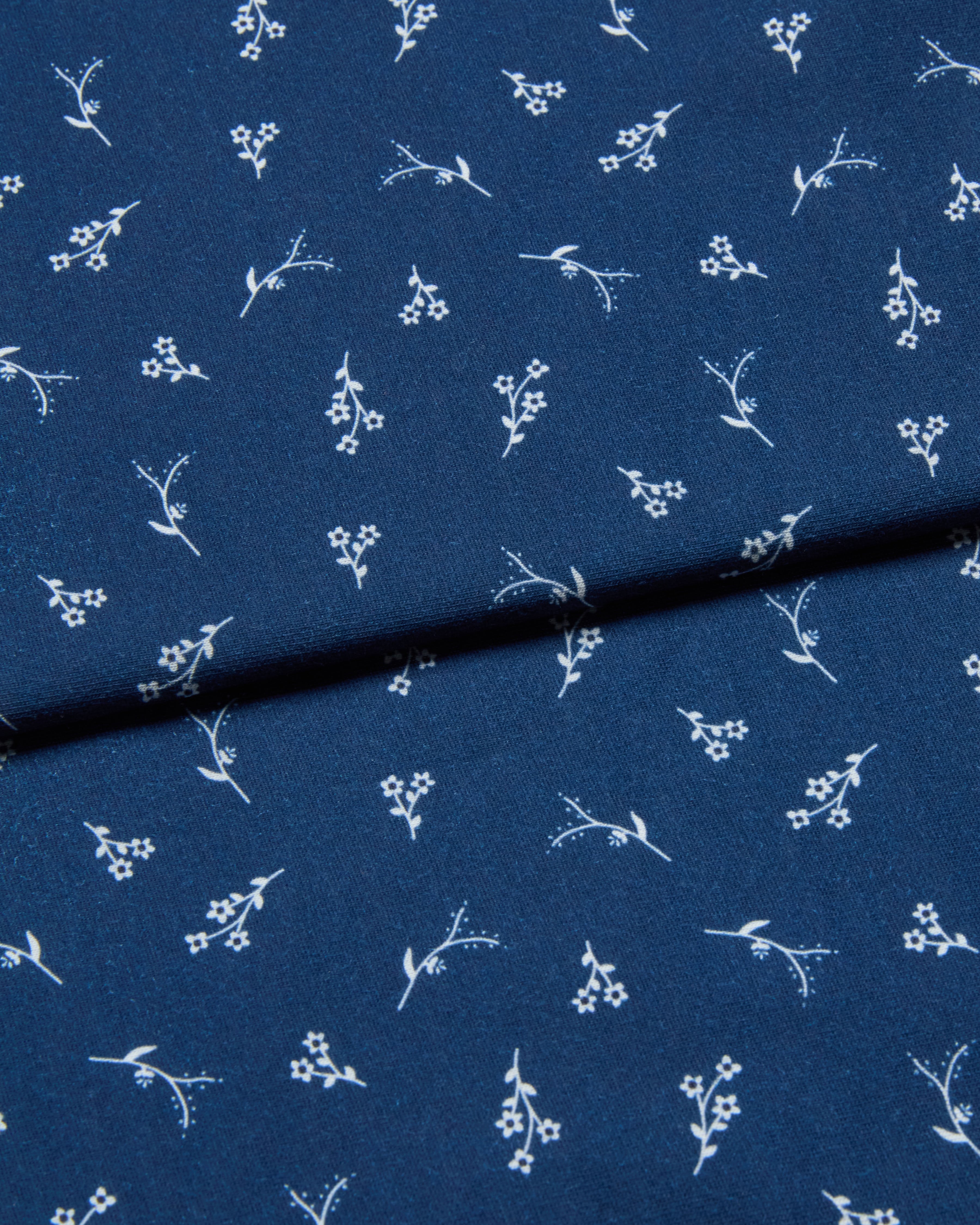 Navy blue jersey fabric with white floral pattern