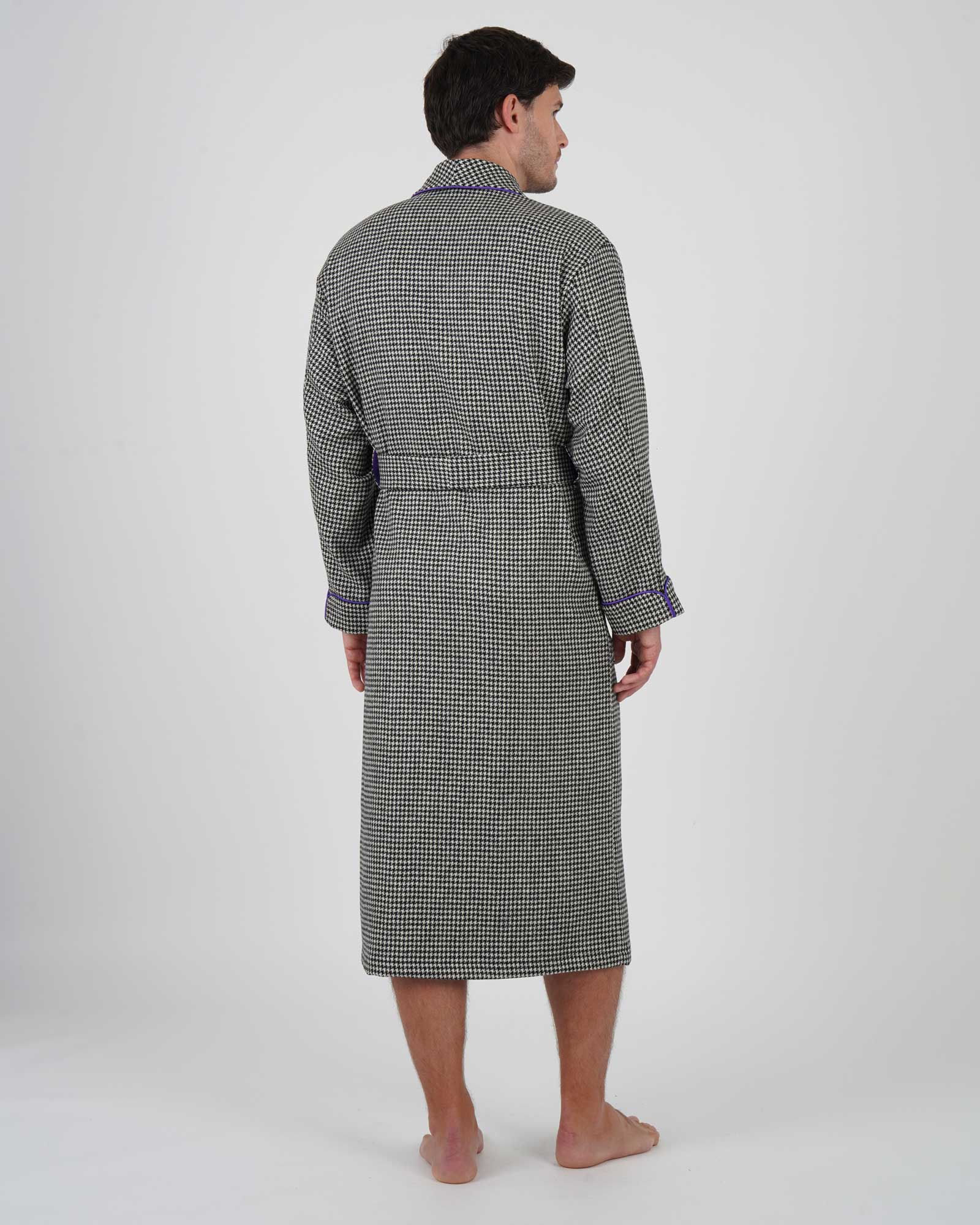 Man wearing a grey wool robe with a black and white houndstooth pattern