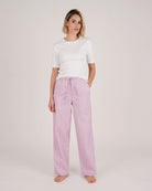 Bonsoir of London women's cotton long pyjama trousers in purple stripe print, elasticated and drawstring waist, full body shot on a model.
