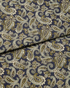 Bonsoir of London silk satin fabric, featuring a navy base with olive green, pale blue and cream paisley design, close up of the fabric.