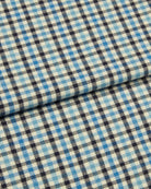 Bonsoir of London brushed cotton fabric, featuring a blue, white and navy check design, close up of the fabric.