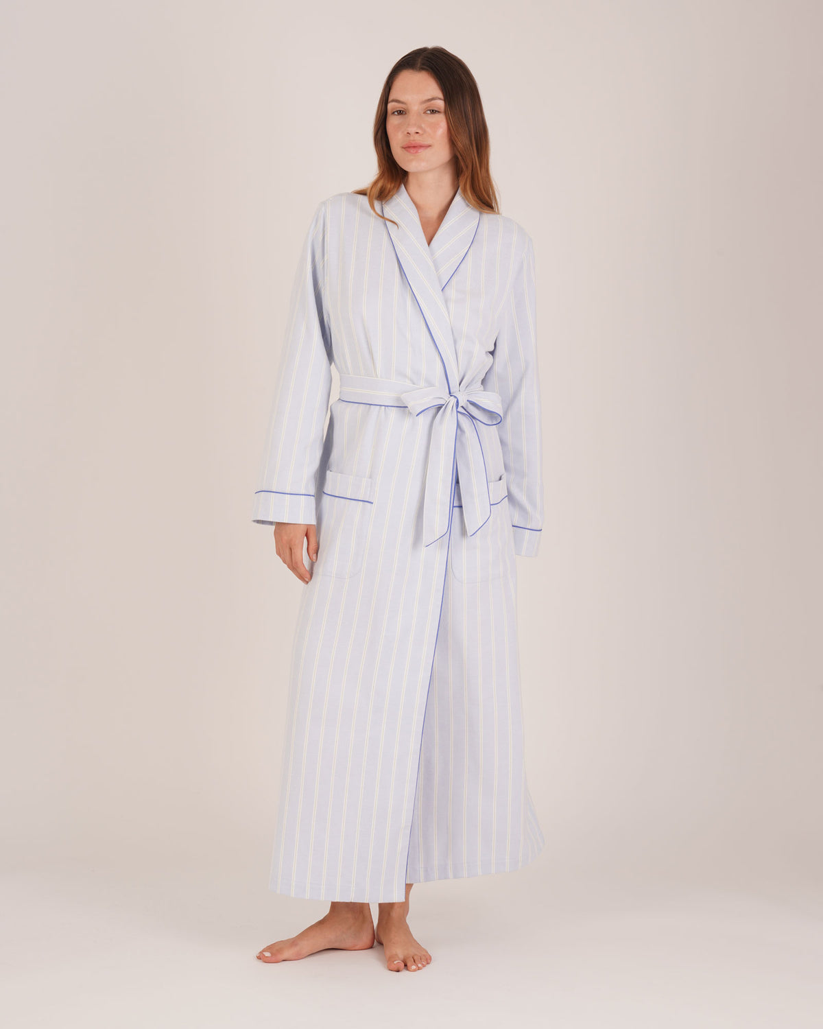 Bonsoir of London Women’s Isla Blue White Stripe Brushed Cotton Dressing Gown, featuring a blue and white striped design, shot on a model.