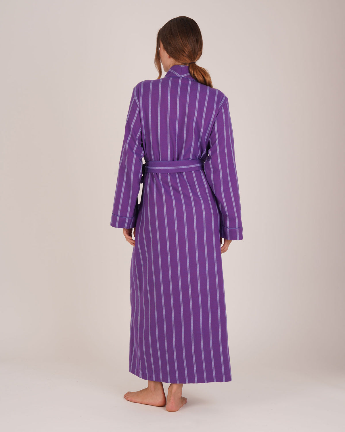 Bonsoir of London Women’s Lily Purple Stripe Brushed Cotton Dressing Gown, featuring a purple striped design, shot on a model from the back.
