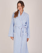 Bonsoir of London Women’s Poppy Blue White Gingham Brushed Cotton Dressing Gown, featuring a blue and white gingham check design, pink piping detail, shot on a model.