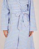 Bonsoir of London Women’s Poppy Blue White Gingham Brushed Cotton Dressing Gown, featuring a blue and white gingham check design, pink piping detail, shot on a model close up.