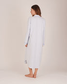 Bonsoir of London Women’s Isla Blue White Stripe Brushed Cotton Nightshirt, featuring a blue and white striped design, button placket, shirt-tail hem, piping detail, cuffs and breast pocket, full body shot on a model from the back.