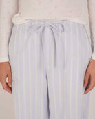 Bonsoir of London Women’s Isla Blue White Stripe Brushed Cotton Pyjama Trousers, featuring a blue and white striped design, relaxed fit, half-elastic and half-drawstring waist, close up shot on a model.