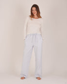 Bonsoir of London Women’s Isla Blue White Stripe Brushed Cotton Pyjama Trousers, featuring a blue and white striped design, relaxed fit, half-elastic and half-drawstring waist, full body shot on a model.