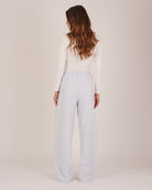 Bonsoir of London Women’s Isla Blue White Stripe Brushed Cotton Pyjama Trousers, featuring a blue and white striped design, relaxed fit, half-elastic and half-drawstring waist, full body shot on a model from the back