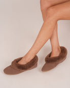 Bonsoir of London Women’s Celia Sheepskin Slippers in Nut, crafted from soft suede with natural sheepskin lining, plush sheepskin collar, suede sole, shot on a model.