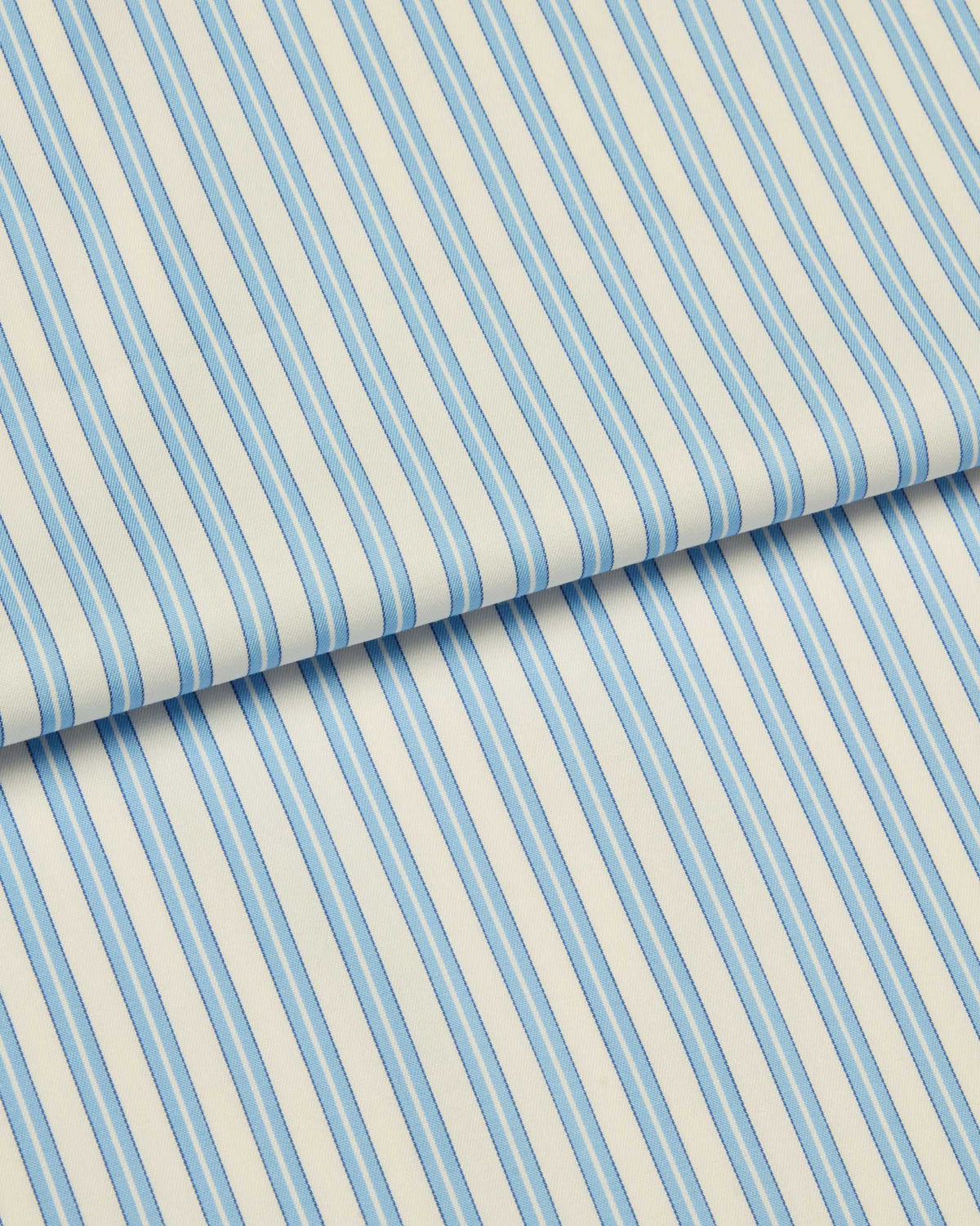 Bonsoir of London two-fold cotton fabric, featuring a blue and white striped design, close up of the fabric.