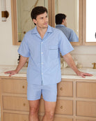 Bonsoir of London men's light blue short pyjamas made from 100% cotton, lifestyle shot in a luxurious bathroom.