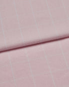 Close-up of pink brushed cotton fabric with subtle white check pattern.