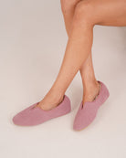 Bonsoir of London Women’s Emily Sheepskin Slippers in Pink, crafted from luxurious Scottish silky suede, real sheepskin lining, classic scalloped front design, suede sole, shot on a model.