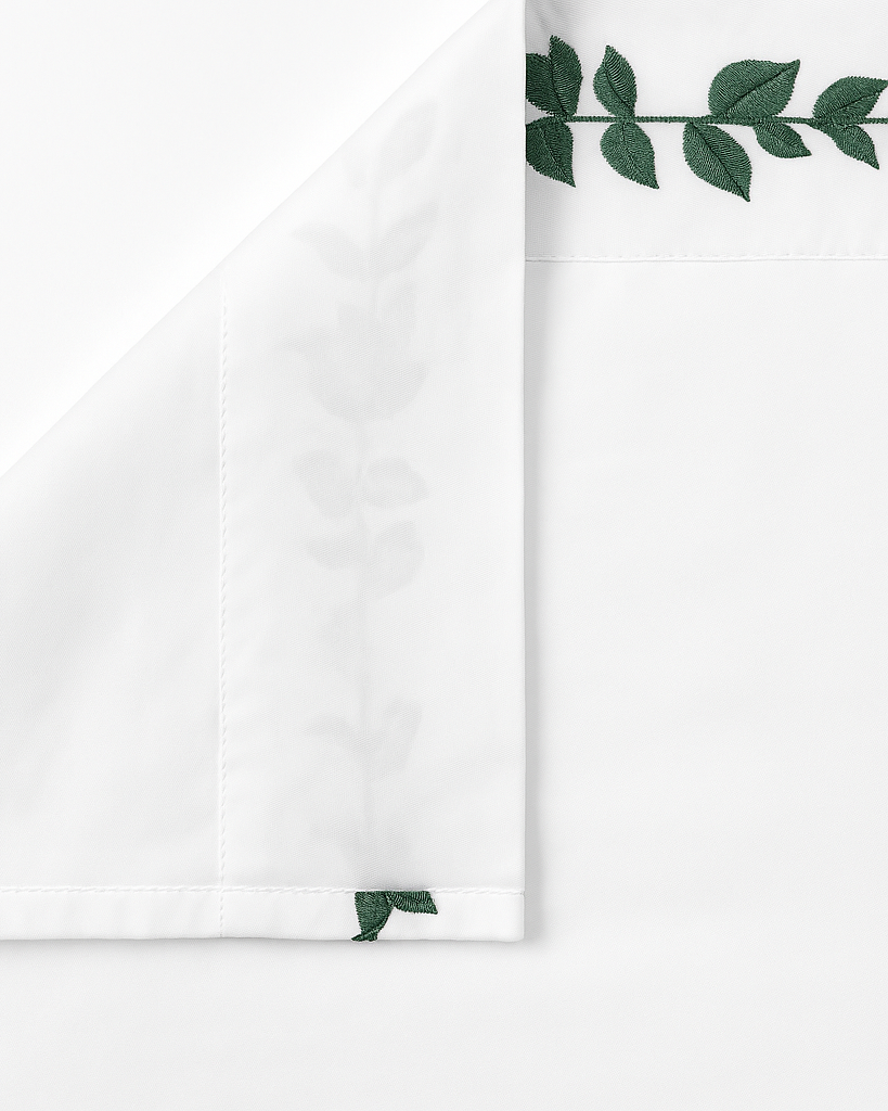 Bonsoir of London White flat sheet with green leaf embroidery, close-up on a white background