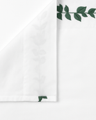 Bonsoir of London White flat sheet with green leaf embroidery, close-up on a white background
