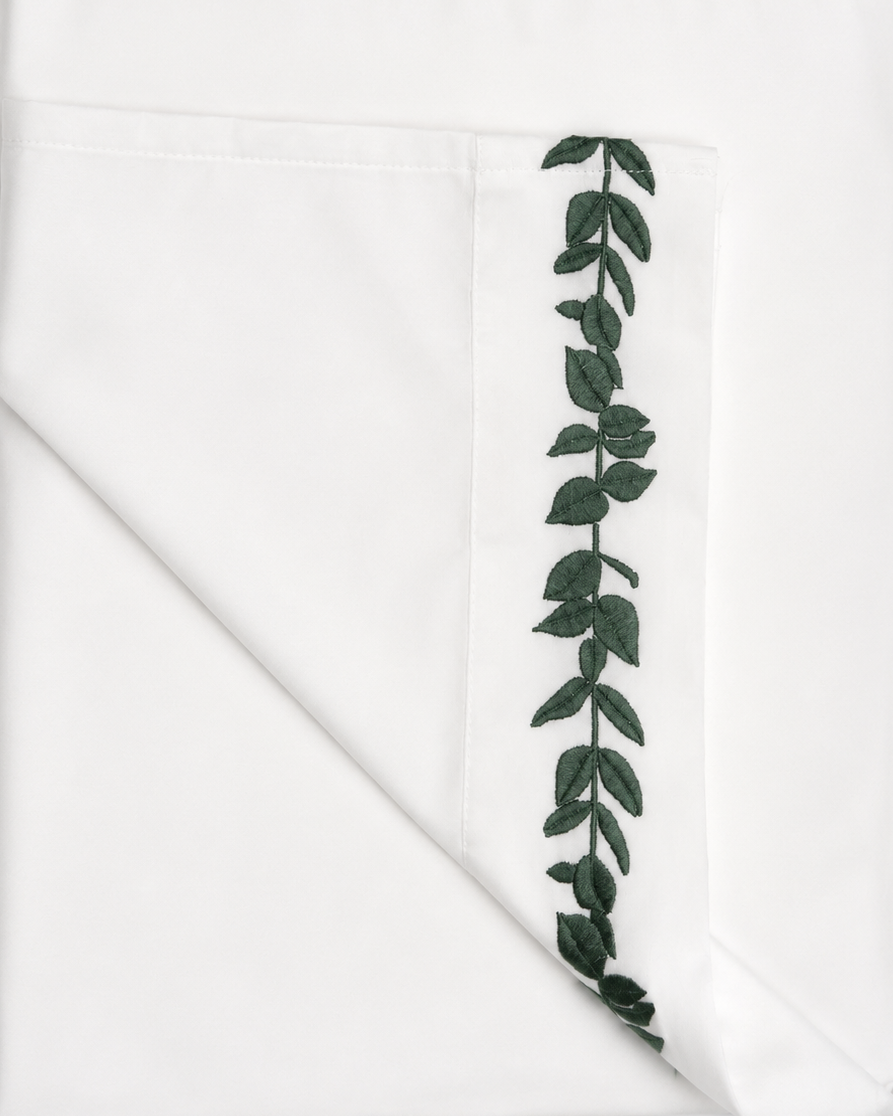 Bonsoir of London white sheet with Green leaf embroidery, closeup detail shot.