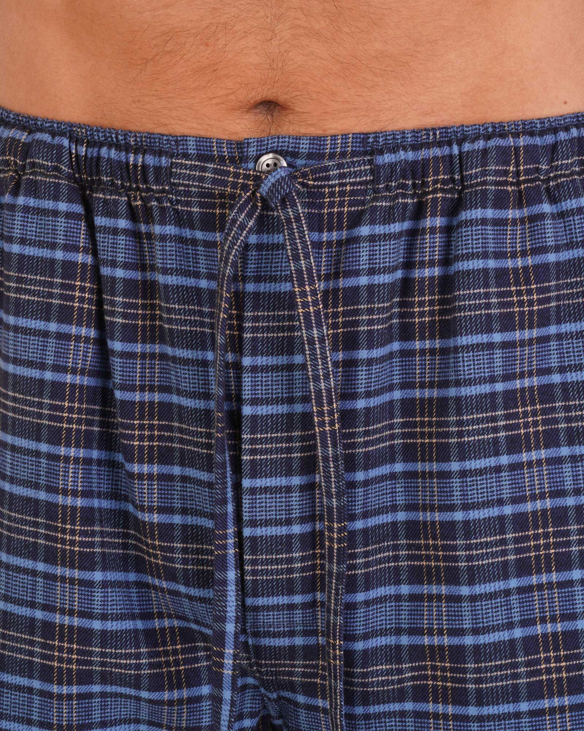 Bonsoir of London Men’s Theodore Blue Plaid Brushed Cotton Pyjama Trousers, featuring a blue and navy plaid design, 100% brushed cotton, fully elasticated waist, concealed button fly, self-fabric drawstring tie and pockets, close up shot on a model.