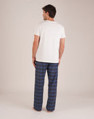 Bonsoir of London Men’s Theodore Blue Plaid Brushed Cotton Pyjama Trousers, featuring a blue and navy plaid design, 100% brushed cotton, fully elasticated waist, concealed button fly, self-fabric drawstring tie and pockets, full body shot on a model from the back.