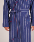 Bonsoir of London Men’s Alexander Navy White Stripe Brushed Cotton Dressing Gown, featuring 100% brushed cotton, a navy and white striped design, shawl collar, wide tie belt and patch pockets, close up shot on a model.