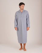 Bonsoir of London Men’s Arthur Blue Check Brushed Cotton Nightshirt, featuring a blue, white and navy check design, four-button placket, shirt-tail hem and generously cut fit, full body shot on a model.