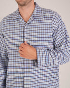 Bonsoir of London Men’s Arthur Blue Check Brushed Cotton Nightshirt, featuring a blue, white and navy check design, four-button placket, shirt-tail hem and generously cut fit, close up shot on a model.