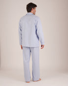 Bonsoir of London Men’s Oliver Blue White Stripe Brushed Cotton Pyjamas, featuring a pale blue and white striped design, three jacket pockets, elasticated-waist trousers, button fastening and concealed button fly, full body shot on a model from the back.