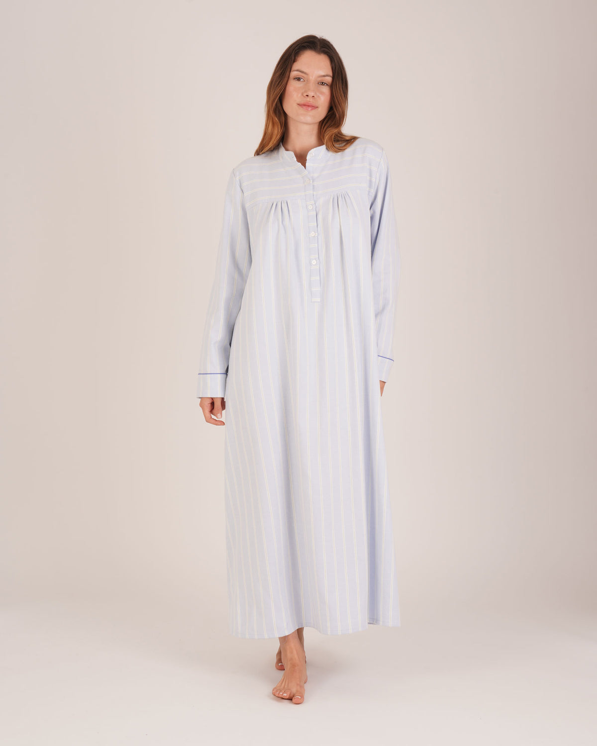 Bonsoir of London Josephine Brushed Cotton Nightdress, Isla Blue White Stripe, featuring long sleeves, button detail, a blue and white striped design, full body shot on a model.