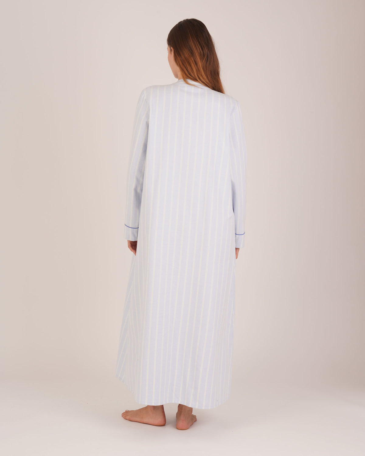 Bonsoir of London Josephine Brushed Cotton Nightdress, Isla Blue White Stripe, featuring long sleeves, button detail, a blue and white striped design, full body shot on a model from the back.