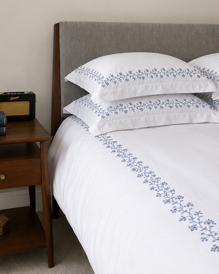 Bonsoir of London Kensington duvet set in Navy, featuring white 100% cotton duvet and pillowcases with navy floral embroidery.