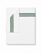 Bonsoir of London white cotton flat sheet with green embroidered stripes, folded on a white background.