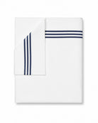 Bonsoir of London folded white sheet with navy blue stripes on a white background.