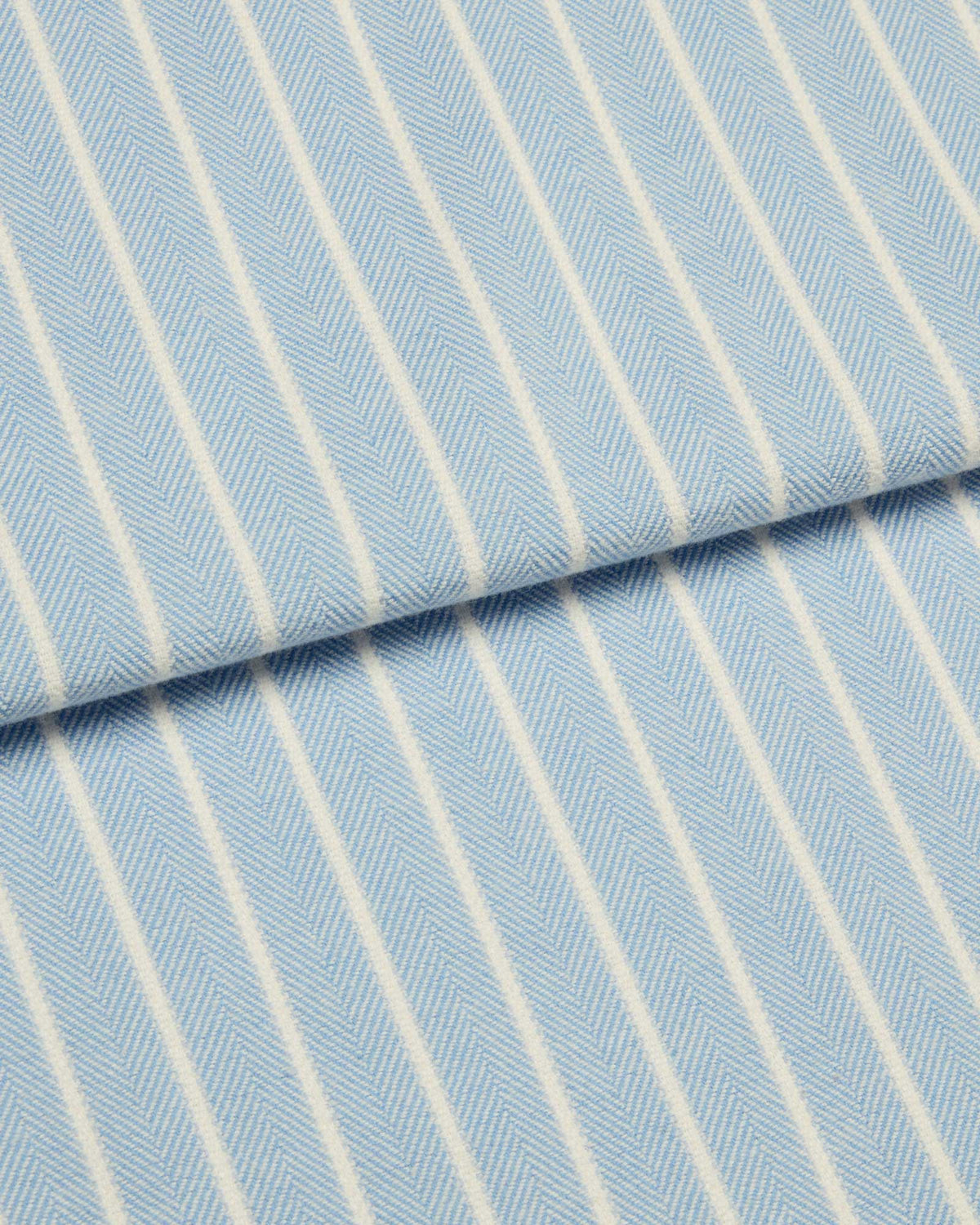 Bonsoir of London brushed cotton fabric, featuring soft pale blue and white stripes, close up of the fabric.