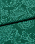 Green fabric with intricate white floral paisley pattern
