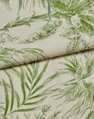 Silk Fabric close-up with green leaf pattern on a cream background